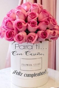 pink roses in a white container on a table