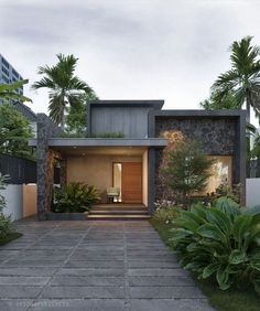 the entrance to a modern home surrounded by greenery