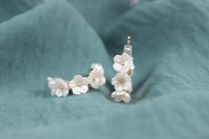 These white floral silver earrings are handmade women earrings. These earrings are simple and elegant accessories that you can easily match with any outfit. These earrings are perfect for gifting yourself or your loved ones. They are great gift options for birthday, wedding, engagement, anniversary, Valentine's day, Mother's day, graduation or any special occasion. These earrings come with gift box and personalized note. The size of the earrings is 1 cm. Color: Gold & White Style: Bridal, Weddings, Special Days, Summer Style Gender: Unisex Shape: Floral, Pearl Material: Cubic zirconia Return policy Our products have a one-day preparation period, during which you can cancel or change your order. If you want to make a return or exchange after your order has been shipped, the shipping charges Anniversary Pearl White Flower Earrings For Pierced Ears, Elegant White Flower Hoop Earrings, Delicate White Hypoallergenic Jewelry, Elegant Flower Hoop Earrings For Anniversary, Elegant Flower-shaped Hoop Earrings Gift, Elegant Flower-shaped Hoop Earrings For Wedding, Delicate White Jewelry With Matching Earrings, Dainty Flower Earrings With Ear Wire For Wedding, White Drop Earrings For Bridesmaid Gift