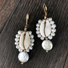 Tiny faux pearl trimmed cowry shells with freshwater coin pearl drop. Gold filled lever back 2” drop Summer Pearl Drop Earrings, Shell-shaped Pearl Earrings With Pearl Charm, Bohemian White Pearl Earrings, Pearl Shell Earrings With Pearl Charm, Bohemian Beaded Pearl Drop Earrings, Summer Pearl Drop Dangle Earrings, Beach Pearl Drop Earrings, Pearl Shell Drop Earrings With Pearl Drop Detail, Elegant Pearl Charm Earrings With Shell