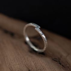 This handcrafted sterling silver ring, made in Paris, is a beautiful representation of two becoming one. Its unique design features two ends that meet and merge, symbolizing unity, connection, and harmony- making it an ideal piece for a wedding band, engagement ring or a meaningful everyday piece. Carefully crafted from a 1.5mm square wire and hammered to achieve a rustic texture, this ring offers a modern yet timeless appeal. The distinct notch detail not only adds character but also serves as Unity Ring, Minimalist Modern Wedding, Modern Wedding Band, Visual Metaphor, Textured Ring, Ring Minimalist, Everyday Accessories, Minimalist Modern, Handmade Sterling Silver