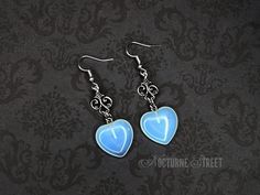 A whimsical pair of dangle earrings designed by Nocturne Street, featuring Opalite hearts and Tibetan Silver charms hanging from Silver Plated hooks. Would look perfect with a witchy or whimsigoth outfit! The length is approximately 6cm including the hook, with the drop length being approximately 4.5cm. The earrings are handmade and will be packaged in pretty organza gift bag so they would make a lovely gift for the wiccan in your life. Visit my shop to see the complete collection of witchy earrings. Only pay one lot of postage, the rest of your order ships free! ✨ Gothic White Dangle Jewelry, Whimsical Drop Earrings For Valentine's Day, White Gothic Dangle Jewelry, Whimsical Valentine's Day Jewelry For Pierced Ears, Whimsical Nickel-free Heart Earrings, Gothic Dangle Earrings For Valentine's Day, Gothic Heart-shaped Pierced Jewelry, Fantasy Style Drop Earrings Jewelry Gift, Fantasy Style Drop Earrings For Gift