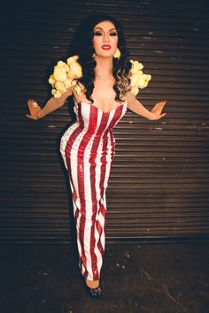 a woman in a red and white striped dress holding flowers