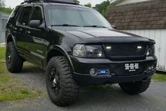 a black truck parked in front of a house