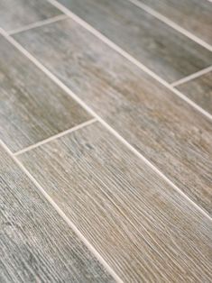 a close up view of a wood look tile floor