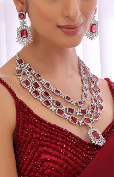 This Stunning Three Layered Ruby Red CZ Long Necklace is a must-have piece of jewelry for anyone looking to make a statement. This stunning CZ necklace features a combination of Indian, Pakistani, and American diamond jewelry, making it a truly unique and eye-catching accessory. Necklace Length Is Adjustable With Extension Chains Earrings Have Pushbacks.  Customized orders takes 3 to 4 weeks, depending on piece requirements.  The Ombre Designs Jewelry pieces can be customized in accordance with your requirement.  Please Email or Whats app on : +91 8448833193 / sonalikamehra@theombredesigns.com Luxury Ruby Necklaces With Polished Finish, Luxury Red Necklaces With Single Cut Diamonds, Luxury Red Diamond Cut Necklaces, Luxury Ruby Necklaces For Anniversary, Luxury Ruby Diamond Necklace In Fine Jewelry Style, Luxury Ruby Jeweled Necklaces, Luxury Red Diamond Necklace Fine Jewelry, Luxury Ruby Necklace With Sparkling Stones, Luxury Ruby Jewelry Sets For Festivals