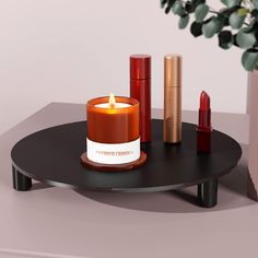 a candle and some lipstick on a table