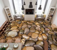 a living room filled with lots of different types of furniture and decor on the floor