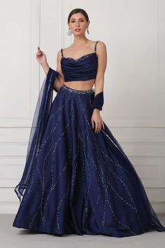 Navy blue lehenga with Swarovski crystals, sequin and bead embellishments. Paired with draped corset blouse and net dupatta.
Component: 3
Pattern: Embellished
Type Of Work: Swarovski crystals, Sequin, Bead
Neckline: Sweetheart
Sleeve Type: Sleeveless
Fabric: Satin, Net
Color: Blue
Other Details: 
Embellished details
Draped corset
Flared lehenga
Net dupatta
Occasion: Wedding, Reception - Aza Fashions Navy Blue Lehenga, Sangeet Outfit, Simple Lehenga, Trendy Outfits Indian, Indian Outfits Lehenga, Lehenga Designs Simple, Lehenga Blouse Designs, Gaun Fashion, Blue Lehenga