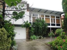 a house that is surrounded by trees and bushes