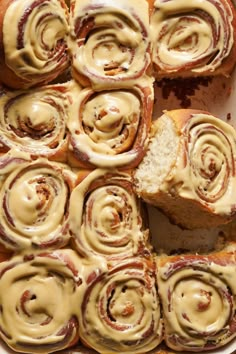 a pan filled with cinnamon rolls covered in icing