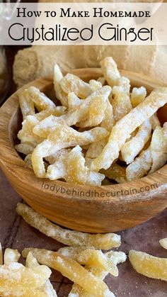 a wooden bowl filled with sugary fried food on top of a table next to sliced ginger