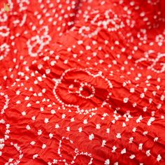 red and white fabric with small flowers on it