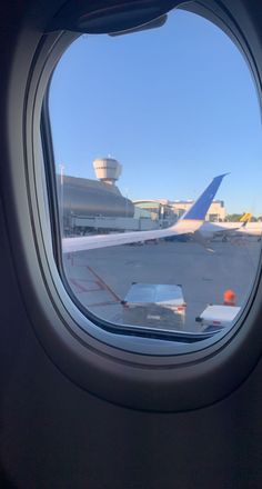 an airplane window looking out on the tarmac