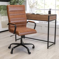 a brown leather office chair sitting in front of a desk