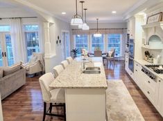 a large kitchen with an island in the middle and lots of counter space on one side