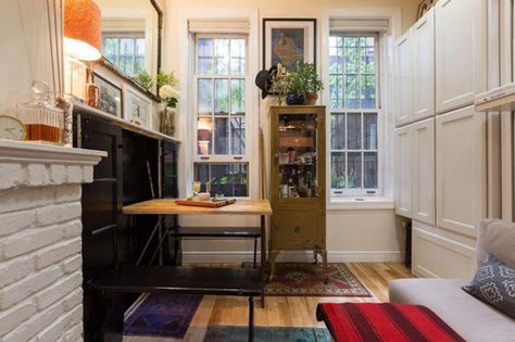 Peep Inside NYC's Coolest Tiny Apartment #refinery29  http://www.refinery29.com/tiny-nyc-apartment-ideas#slide-6  A pocket table unfolds from the cabinet. New York Studio Apartment, West Village Apartment, Affordable Apartments, Micro Apartment, Tiny Apartments, Small Apartment Living, New York Apartment, Tiny Apartment, Nyc Apartment