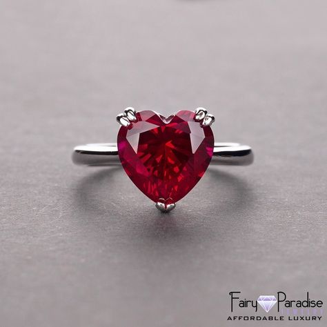 "The fiery beauty of this red heart-shaped center stone (10mm, about 4 carats) symbolizes everlasting love. This heart-cut double prong solitaire ring features with 925 sterling silver band. The width of the band is about 2.4mm. Heart cut diamonds are very popular as the shape is associated with love and all things romantic. The appeal and marketability of heart cut stone are like a double incentive for you to consider getting one. Not surprisingly, this particular shape is a very popular choice Garnet Heart, Promise Rings For Her, Sterling Silver Engagement Rings, Red Diamond, Heart Shaped Diamond, Heart Gemstone, Silver Wedding Rings, Silver Engagement Rings, Red Ruby