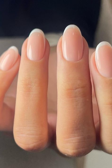 Timeless elegance in a manicure! The nails are crafted with a soft almond shape, featuring a classic French tip that's flawlessly executed with crisp white borders. The nude base complements the white perfectly, creating a sleek and sophisticated look suitable for any occasion. Perfect for those who appreciate a chic, refined style.  // Photo Credit: Instagram @nailhousebydiana Classic Short Almond Nails, Classic Squoval Nails, French Nails Ideas Oval, French Tip Gel Manicure Natural Nails, Classic Nail Shape, Clear Wedding Nails, Manicure Ideas Almond Shape, French American Nails Natural, French Manicure Square Round