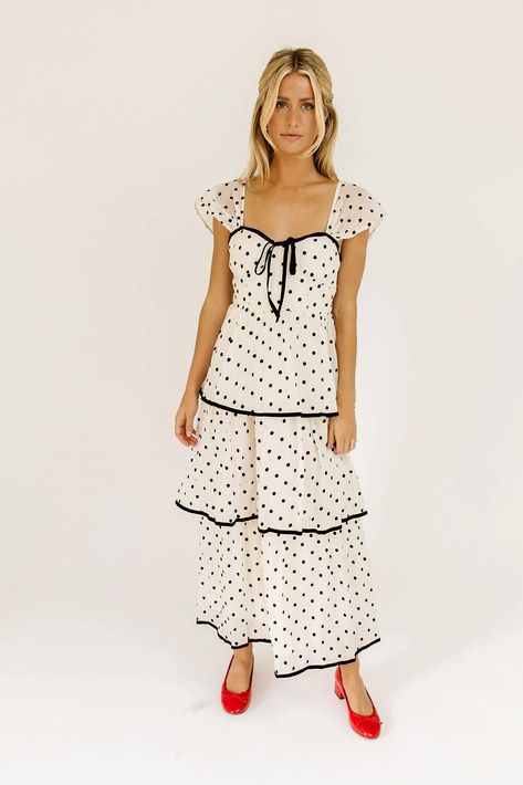 the retro-inspired dress of our dreams. it features sheer short sleeves, a ribbon tie bodice, + dainty ruffle details. both sweet + sophisticated, this off-white + black polka dot midi dress is perfect for fancy dinner dates, holiday parties, + anytime you’re feelin’ frilly.  off white + black polka dots // midi length Winter Ball Dresses, Midi Dress Winter, Party Dresses With Sleeves, Retro Inspired Dress, Polka Dot Midi Dress, Winter Formal Dresses, Dinner Dates, Sheer Shorts, White Polka Dot Dress