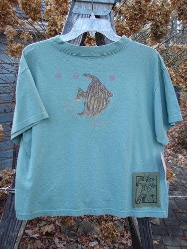 This New With Tag Short Sleeved Tee is from the Spring Collection of 1994 in Seagrass in Perfect Size 3 Condition made from Cotton Jersey. The features Include: The Very Limited Size 3 Crop Shape ~ A Wide But Slightly Shallow Thicker Ribbed Neckline ~ A Slight Bottom Flair ~ Sweet Fish Bowl Theme Paint and The Signature Blue Fish Poetry Patch! The Measurements are as Follows: Bust 44 ~ Waist 44 ~ and the Length is 22 Inches. Shark Tank Top, Fish Outfit, Fish T Shirt, Fish Clothing, Fish Shirt, Embroidered Tee, Blue Fish, Fire Fits, Fishing Outfits