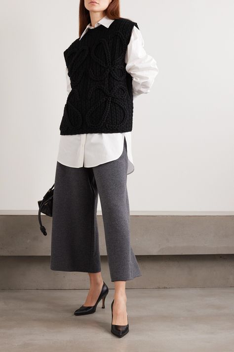 Loewe's vest features a scaled-up version of its signature 'Anagram', originally designed by Spanish artist Vicente Vela in 1970. It's cable-knitted from chunky wool with a soft, textured handle. Wear it solo or layered over oversized shirts. Oversized Vest Outfit, Knit Vest Outfits For Women, Gilet Outfit Women, Sweater Vest Outfit Women, Black Knitted Vest, Knit Vest Outfit, Sweater Vest Outfit, Long Sweater Vest, New York Outfit