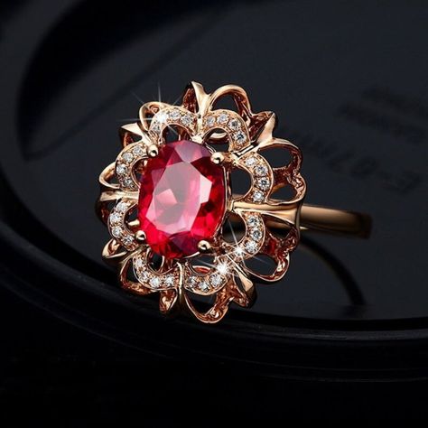 Brand New Ring Made Out Of Rose Gold Plated 925 Sterling Silver With An Oval Shaped Created Ruby Set In The Center In A Halo Shaped Design. The Halo Is 5/8" X 3/16" Large And The Center Stone Is 3/16" X 5/16" Large. The Ring Weighs 6 Grams. R0489-94 Large Ruby Ring, Red Ruby Rings, Red Quince Ring, Ruby Nose Pin, Gold Elegant Jewelry, Gold Ruby Jewelry, Women Rings Gold Design, Oval Ruby Ring Design, Gem Rings Stones