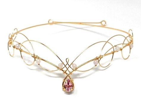 Rose pink crystal tiara circlet in gold made to be worn over the forehead or on the hairline. Inspired by the never ending celtic knot designs found in Scotland and Ireland this tiara features a premium pear shaped crystal in rose pink at the centre and smaller faceted rose pink quartz  gemstones around the sides. Equally suitable for both weddings for brides and bridesmaids as well as costumes. Entirely handmade which makes it comfortably flexible, but this also means that it will need to be pinned or tied into place. The circlet measures 52cms (21 inches) in circumference, and the design area measures approx 21cms wide and 3cms in height. Celtic Crown, Wedding Circlet, Bridal Circlet, Pink Tiara, Jewelled Headpiece, Elven Wedding, Twist Jewelry, Celtic Knot Designs, Crystal Tiara