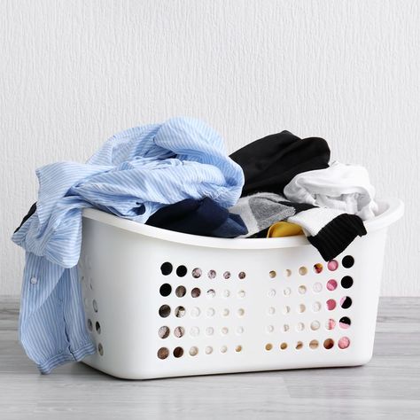 Basket with dirty laundry on floor against light wall Kain Linen, Habit Stacking, Laundry Symbols, Wash And Fold, Dry Cleaning Services, Cleaning Tricks, Doing Laundry, Laundry Hacks, Dirty Laundry