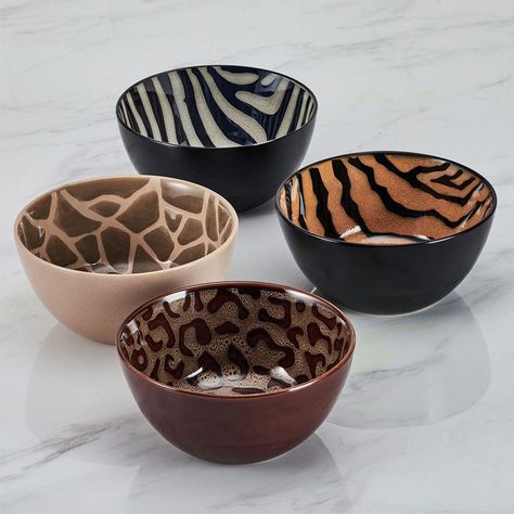 This Amari Dinnerware Bowl Set features four animal print designs: cheetah, zebra, tiger, and giraffe, on a distinctive reactive glaze finish. Due to the nature and hand-crafted qualities of reactive glaze, no two pieces are exactly alike and will exhibit unique variations in color and pattern. Product may slightly differ from image shown.• 12-piece set, service for 4, includes 4 each 8-1/2 inch dinner bowl with a 38-fluid ounce capacity, 6 inch pasta bowl with a 25-fluid ounce capacity, and a 9 Ceramic Plate Set Dinnerware, Dishwear Sets Dinnerware, Cute Plates And Bowls, Unique Dishware, Cool Apartment Decor, Cool Cups, Cute Bowls, Unique Dinnerware, Dinnerware Set Modern