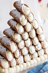 Serve your guests a mountainous pile of cannoli instead of a wedding cake. http://www.buzzfeed.com/nataliebrown/dreamy-alternatives-to-traditional-wedding-cake?crlt.pid=camp.PQRHxEiDwME8 Wedding ideas Canoli Table Wedding, Wedding Cannoli, Cannoli Tower, Non Traditional Wedding Cake, Unique Wedding Food, Italian Custard, Ricotta Cream, Cannoli Cake, Cake Alternatives