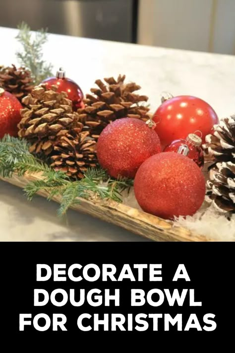 How to Decorate a Dough Bowl for Christmas How To Decorate With Dough Bowls, How To Decorate A Wooden Trough, How To Style A Dough Bowl For Christmas, Wooden Bowls Decor Ideas Christmas, Bread Bowl Decor Centerpieces Christmas, Bread Bowl Christmas Centerpiece, Christmas Bowl Decor, Dough Bowls Decorated For Christmas, Wooden Bowl Christmas Decor