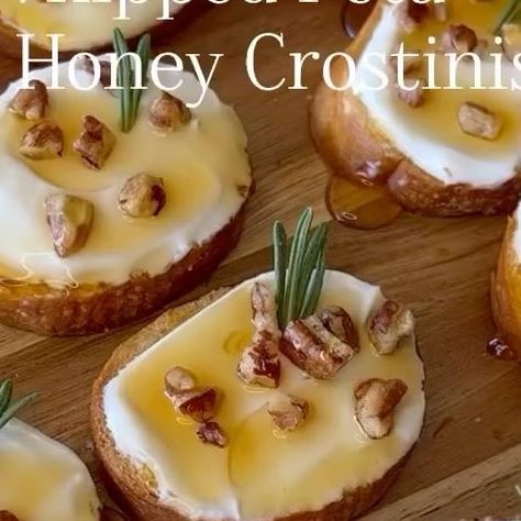 Women's Clinic of Lincoln, P.C. on Instagram: "We are loving this easy holiday appetizer from @spoonfulofsi Ingredients: 1 baguette 1/4 cup olive oil 2 tbsp sea salt 7 oz feta cheese 1/3 cup cream cheese 1/2 cup honey roasted pecans 2-3 fresh rosemary sprigs 1/4 cup hot honey Instructions: 1. Preheat oven to 400°. Slice baguette into rounds. Place on baking sheet and drizzle with olive oil. Sprinkle with sea salt. Bake 10 to 13 minutes or until golden. 2. Combine the feta and cream cheese. Blend until smooth. 3. Spread whipped feta onto baguette slices. Arrange in a single layer on serving dish. 4. Sprinkle each crostini with chopped pecans and a fresh rosemary sprig. Drizzle with hot honey." Whipped Feta Hot Honey Crostini, Baguette Toppings, Baguette Crostini, Cream Cheese Crostini, Baguette Appetizer, Honey Appetizers, Football Tailgate Food, Honey Roasted Pecans, Best Thanksgiving Appetizers