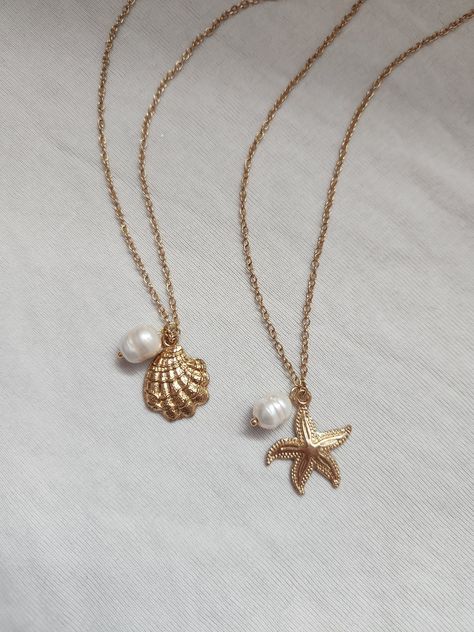 -seaside girl necklace- miss the ocean? bring a little of it with you with this coastal-themed necklace! seaside girl starfish necklace: features a starfish charm, freshwater pearl charm, gold chain, lobster clasp, and extension chain. details:  - 38 cm without extension  - 43 cm with extension  - comfortable & durable  - handmade with love seaside girl shell necklace: features a shell charm, freshwater pearl charm, gold chain, lobster clasp, and extension chain. details:  - 38 cm without extension  - 43 cm with extension  - comfortable & durable  - handmade with love feel free to message me if you have any questions or concerns! Shell With Pearl Necklace, Sea Shells Necklace, Dope Jewelry Accessories, Coastal Jewelry, Surf Jewelry, Summer Jewellery, Ocean Inspired Jewelry, Pandora Jewelry Charms, Preppy Jewelry