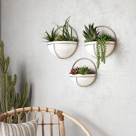 This trio of glossy white planters will add depth and interest to any modern space. Each planter is in a half-moon shape and set in a gold metal frame. Crafted entirely out of metal, they're a chic piece that work with industrial, mid-century modern, or eclectic styles. Place your favorite faux plants or succulents inside then hang with ease. Size: 13"H x 13"W x6.5"D/11.5 x 11.5 x5.5/10.5 x 10.5 x5. Metal Wall Planters, Planters Indoor, Wall Planters Indoor, Plant Wall Decor, Wall Planters, Plant Room, White Planters, Decorative Planters, Boho Chic Furniture