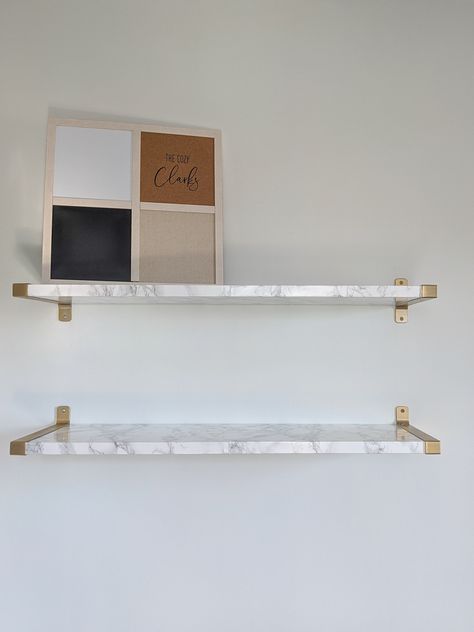 Click to see how I made these Ikea hack marble and gold floating shelves—and let me know whether you think it was a flip or a flop. Marble Shelves Living Room, White And Gold Floating Shelves, Marble Shelves Bathroom, Diy Marble Shelves, White And Gold Shelves, Ikea Floating Shelves Hack, Marble Floating Shelves, Marble Shelf Bathroom, Floating Marble Shelf