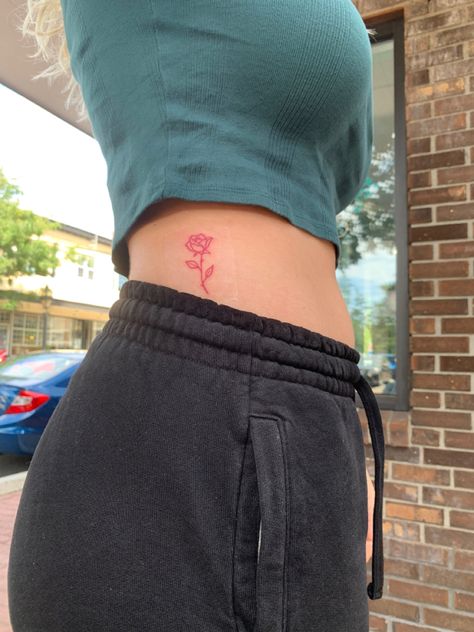 Hidden Rose Tattoo, Fine Line Red Ink Rose Tattoo, Word Rose Tattoo, Rose Placement Tattoo, Red Rose Spine Tattoo, Rose Tattoo Placement Ideas For Women, Fine Line Red Rose Tattoo, Red Rose Tattoo Outline, Rib Cage Rose Tattoo