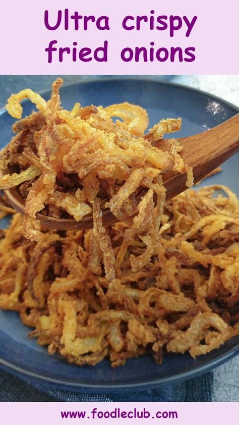 A spoonful of crispy frien onions held over a blue plate. Onion Crisps Fried, Air Fried Crispy Onions, How To Make Crispy Onions, Homemade Fried Onions, Fried Onions For Burgers, Air Fryer Crispy Onions, French’s Crispy Fried Onions Recipes, Crispy Fried Onions Recipes, Crispy Onions Topping