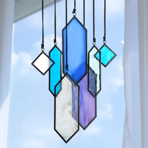 PRICES MAY VARY. Unique Element Earth Tones Designs: This set of 7 stained glass panels features exquisite designs inspired by earthy tones, adding a touch of elegance and vibrancy to any space.Size 1.3*2in (2pcs), 1*4.3in(2pcs), 1.9*5.5in(3pcs). Each piece has its own string that come tied on and ready for use. WOOD STICK /WINDOW SUCTION CUP NOT INCLUDED Premium Materials: Made from high-quality stained glass , these panels offer durability and longevity. The carefully selected colors and textu Window Panel Decor, Hanging Suncatchers, L'art Du Vitrail, Element Earth, Indoor Window, Glass Wind Chimes, Stained Glass Window Hanging, Stained Glass Diy, Stained Glass Crafts