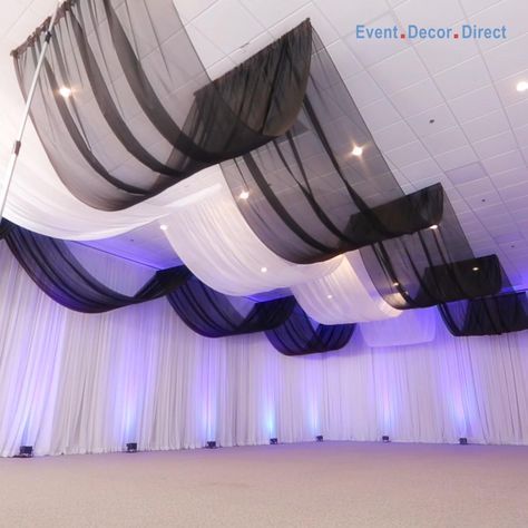 EventDecorDirect.com is the #1 supplier of professional ceiling draping kits at factory-direct prices. Choose from a huge variety of styles, colors and sizes. We also offer accessories that allow you to drape a ceiling without a ladder! Our ceiling draping kits are ideal for weddings, events, parties, corporate events, banquet halls, event centers and much more. Enjoy FREE SHIPPING on all of our ceiling draping kits. Shop Now at EventDecorDirect.com | Questions? Call Us Today 1-800-914-3538 How To Decorate A Ceiling For A Party, Roof Draping Ideas, Wisteria Chandelier Wedding Diy, How To Hang Ceiling Draping, Event Hall Decor Ideas, Ceiling Draping Diy, Party Hall Decor Ideas, Fabric Ceiling Ideas, Ceiling Decorations For Party