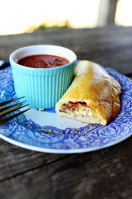 Calzones. Notes from Kelley - Next time I will either make my own dough or buy the premade pizza dough at the store. Don't use the Rhodes Rolls. The flavor is fine but they are small and hard to stretch to fit the filling without the dough ripping. Once prepared you can place on a sheet pan until frozen then pop into ziplock bags to store and you can cook them from frozen! Also added raw bell peppers to filling. Easy Calzones, Frozen Dinner Rolls, Pioneer Women Cooks, Calzone Recipe, Freezer Recipes, Pizza Pockets, Make Ahead Freezer Meals, Pioneer Woman Recipes, Ree Drummond