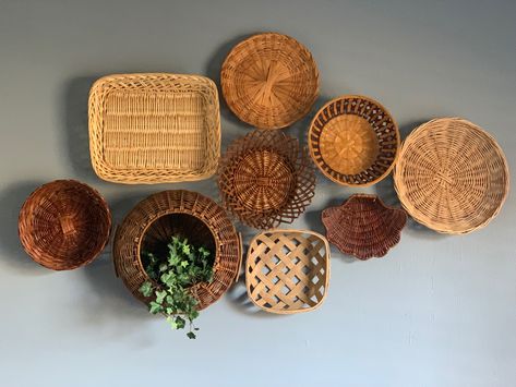 My home has a mix of styles. I’m going for a Boho/ dark academia/ mid century modern/ industrial look. This is a Boho inspired decor. Basket Wall Decor Bathroom, Basket On Wall For Storage, Basket Wall Displays, Wicker Plate Wall Decor, Circle Basket Wall Decor, Wicker Basket Wall Art Living Room, Basket Wall With Plants, Thrifted Basket Wall, Basket Wall Above Bed