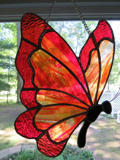 Hand crafted stained glass orange/red butterfly suncatcher created with care in our home shop using quality materials. The glass is variegated orange with variegated red wingtips.  Each piece is uniquely made, none is like the one before it. Each piece is designed to add beauty and charm to your home for many years to come. The glass looks different in different lights, so actual color may be slightly different, although every effort has been made to show accurate color. Stained Glass Butterflies Pattern, Stain Glass Butterflies, Butterfly Stained Glass Pattern, Suncatchers Diy, Butterfly Stained Glass, Stained Glass Cardinal, Crystal Suncatchers Diy, Glass Butterflies, Butterfly Suncatcher