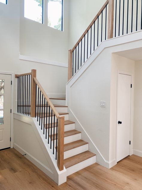 Modern Farmhouse Wrought Iron Staircase. Flooring And Stairs Ideas, Farmhouse Spindles Stairs, White And Wood Stair Railing, Wood Stairs Iron Railing, Affordable Stair Railing, Iron Rod Staircase Railings, Stairway In Middle Of House, White And Iron Stair Railing, Add Railing To Stairs