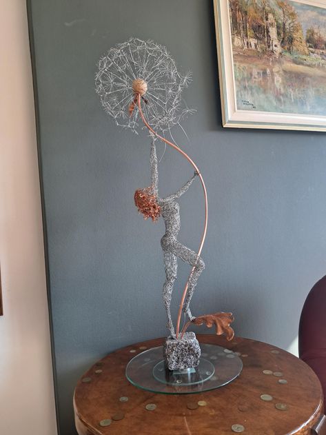 Picking Wishes wire sculpture Keep it Magical and fun with this unique Pick your Wish Dandelion Fairy, stretching to pluck at dandelion seeds and maybe send wishes your way :) This is a statue that can be an exquisite and stunning focal point in your living, library, or office space, placed on a table or a mantelpiece. One-of-a-kind interior home design art, a wonderful present for any occasion, or a unique gift for a loved one. Made from steel wire, the hair locks are shiny copper wire. The dan Copper Wire Sculpture, Electric Wire Art, Copper Pixie, Dandelion Fairy, Metal Wire Art, Wire Angel, Sculptures Sur Fil, Pixie Art, Wish Dandelion