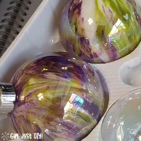 Make these fun DIY Paint Pour Christmas Ornaments in a variety of colors for an inexpensive and budget friendly Christmas Craft you can give as gifts to family and friends. It's a great neighbor gift idea too. Your holiday tree will be beautiful and unique with acrylic pour ornaments you make yourself with this easy How to tutorial. #girljustdiy Paint Poured Ornaments, How To Paint The Inside Of An Ornament, Diy Pour Paint, Diy Painting Christmas Ornaments, Pour Painting Christmas Ornaments, Paint Pour Ornaments Diy, Christmas Paint Pour Ideas, Pour Paint Christmas Ornaments, Painting Ideas For Christmas Ornaments