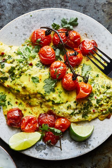 NYT Cooking: A coconut-milk dressing infused with garlic, ginger, turmeric and lime coats fish fillets in this sheet-pan dinner. Accompanying the fish are bright bursts of tomatoes which turn jammy under the broiler and relinquish some of their juices to the pan sauce. This sauce is silky enough to coat a spoon and packed with flavor. It pairs well with anything from snapper to flounder and even salmon, so ... African Books, Baked Tomato Recipes, Tomato Bake, Coconut Fish, Baked Tomatoes, Nyt Cooking, Baked Fish, Fish Fillet, Crushed Tomatoes