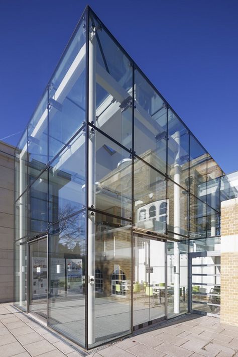 A new community centre adjoining the historic St John’s church in Egham, UK with a central glazed, 6.5-metre-tall glass box with a partially glazed roof made of Pilkington Planar™ structural glazing system. Glass Box Architecture, Mini Chalet, Exeter Cathedral, Georgian Buildings, Roof Skylight, Glass Facade, Glass Elevator, Glass Extension, Community Centre