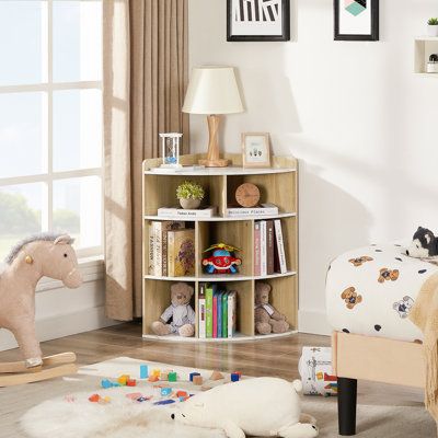 This small bookcase turns an empty corner into a functional storage and display space. It's crafted from engineered wood in a neutral hue that goes with a variety of color schemes. The design features three tiers of open shelf compartments great for books, decor, toys, and more. We love that the top is big enough for a table lamp or vase, as well as a warm beverage. Plus, this petite corner bookcase is also scratch- and chip-resistant for holding up to everyday use. Color: Marble White | Wade Lo Nursery Room Bookshelf Ideas, Book Shelves Nursery, Nursery Bookshelf Ideas, Wooden Cube Storage, Nursery Toy Storage, Room Bookshelf Ideas, Nursery Book Storage, Cube Storage Organizer, Kids Book Storage