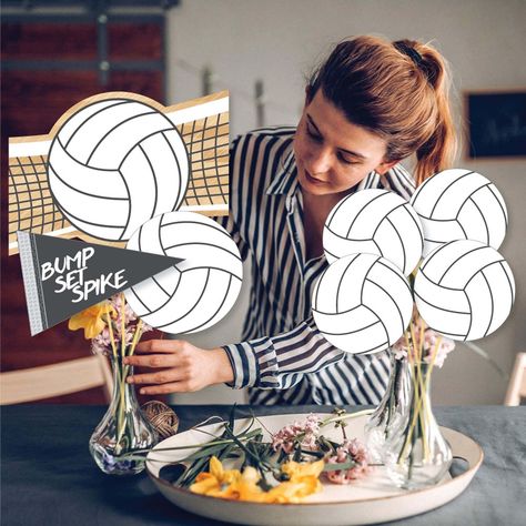 Whether hosting a large group celebration with multiple tables or inviting your closest friends over for a Bump, Set, Spike - Volleyball baby shower or birthday party, create easy DIY party centerpieces with our 35-piece showstopper table toppers. Bump, Set, Spike - Volleyball table topper cut-outs are professionally printed double-sided on sturdy cardstock paper with a photo-like shine and include 35 table topper sticks and clear stickers for at home assembly. Add assembled centerpiece sticks t Volleyball Photo Backdrop, Volleyball Decorations Parties, Volleyball Table Centerpieces, Volleyball Party Ideas Decorations, Diy Volleyball Decorations, Volleyball Table Decorations, Volleyball Centerpieces Banquet, Volleyball Banquet Ideas Centerpieces, Volleyball Balloon Arch